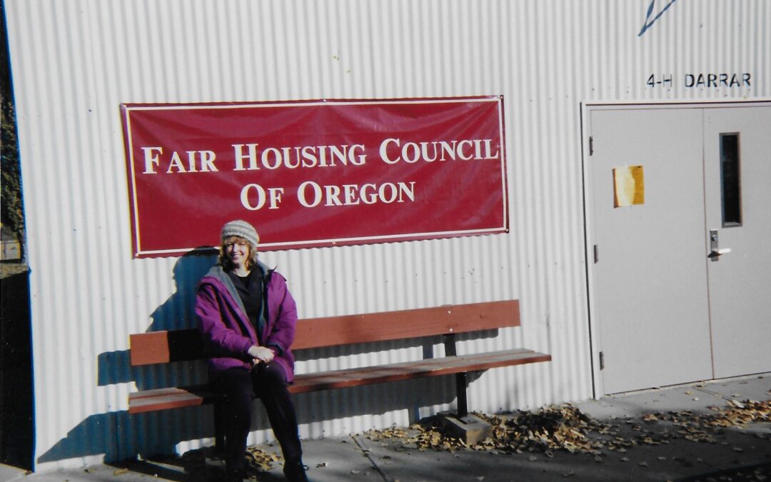 smiling woman sitting on bench in front of FHCO banner